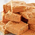 Homemade buttermilk fudge with nuts on a plate.