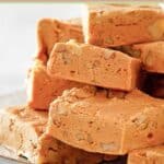 Homemade buttermilk fudge pieces stacked on a plate.
