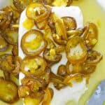 Candied jalapenos and cream cheese on a platter.