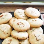 A bunch of homemade Chinese almond cookies on a square platter.
