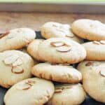 A pile of homemade Chinese almond cookies on a square platter.