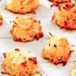 Homemade coconut macaroons on a wood surface.