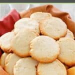 Homemade cream cheese cookies in a basked lined with a kitchen towel.