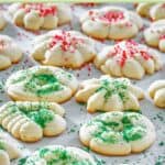 Homemade cream cheese spritz cookies with sprinkles and sanding sugar on top.