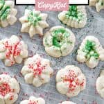 Homemade cream cheese spritz cookies with sprinkles on parchment paper.