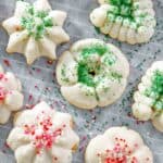 A few cream cheese spritz cookies on parchment paper.