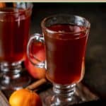 Homemade wassail in mugs on a wood tray.