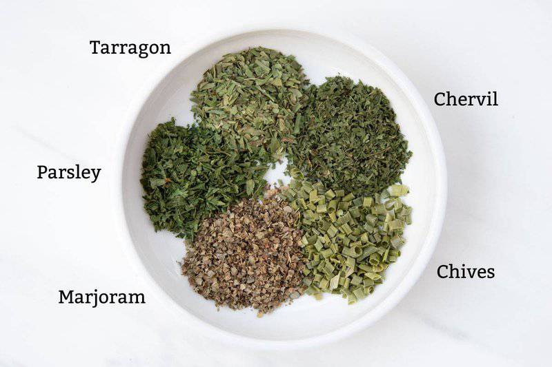 Ingredients for homemade fines herbs in a small bowl.