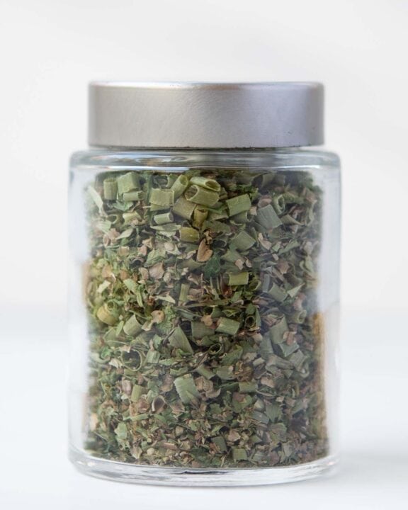 Homemade fines herbes in a spice jar.