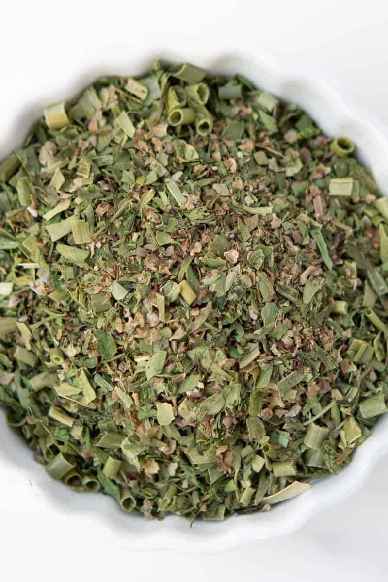 Homemade fine herbs blend in a small bowl.