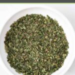 Homemade fines herbes blend in a small bowl.