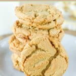 Homemade ginger snaps in a stack on a plate.