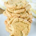 Homemade ginger snap cookies stacked on a plate.