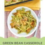A serving of green bean casserole with cheese on a small plate.