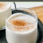 A glass of homemade milk punch garnished with nutmeg.