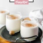 Glasses of homemade milk punch garnished with nutmeg.