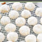 Homemade pecan sandies cookies on a round wire rack.