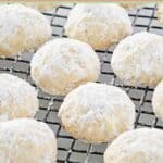 Homemade pecan sandies on a wire cooling rack.