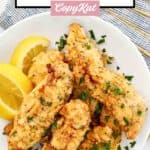 Homemade Piada fried chicken tenders and lemon wedges on a plate.