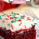 Red velvet brownie with cream cheese frosting and sprinkles on a plate.