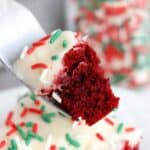 Red velvet brownie with cream cheese frosting on a fork.