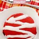 Red velvet pancakes on a plate and a fork on a cloth napkin.