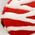 Red velvet pancakes topped with a drizzle of cream cheese glaze.