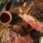 Oven baked roast beef on a cutting board.