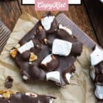 Homemade rocky road candy with walnuts on a wood board.