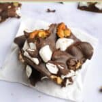Homemade rocky road candy with walnuts on a marble surface.