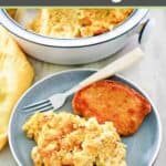 Southern cornbread dressing on a plate with a pork chop, and a fork.