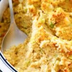 Southern cornbread dressing and a spoon in a baking dish.
