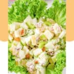 Creamy waldorf salad on top of leaf lettuce.