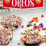 White chocolate covered oreos decorated with sanding sugar and sprinkles.