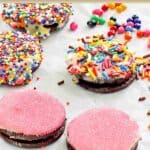 Decorated white chocolate oreo cookies on parchment paper.