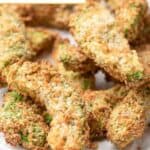 Crispy air fryer avocado fries piled on a plate.