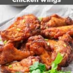 Air fryer sweet and spicy chicken wings and fresh parsley on a plate.