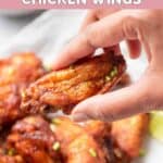 Hand holding an air fryer sweet and spicy chicken wing.