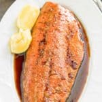 Baked salmon with brown sugar soy sauce on a platter.