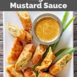 Homemade Benihana magic mustard dipping sauce and egg rolls on a platter.