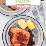 Homemade Cheddar's grilled salmon with bourbon glaze, lemon wedges, and forks.