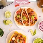 Crockpot chicken tacos on two plates.