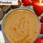 Homemade melting pot chocolate fondue in a bowl and dippers on skewers around it.