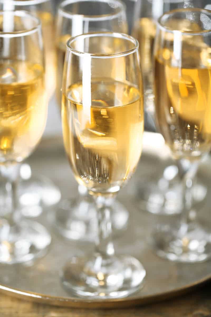 Mock champagne in flute glasses on a tray.