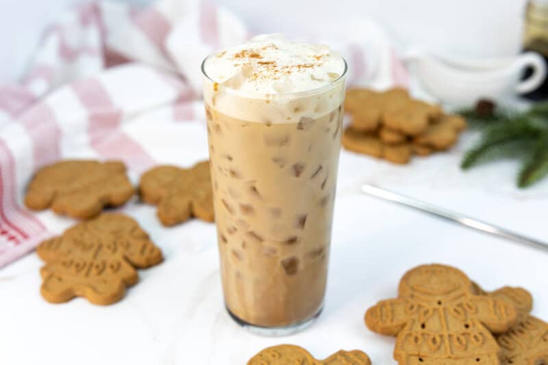Copycat Starbucks iced gingerbread oat milk chai latte drink in a tall glass.