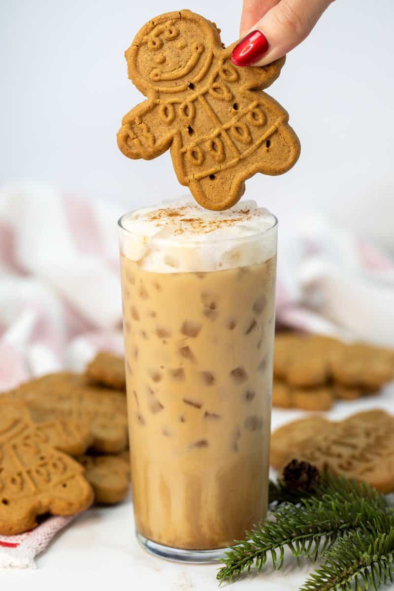 Copycat Starbucks iced gingerbread oat milk chai latte and a gingerbread cookie over it.
