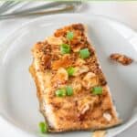 Air fryer salmon almondine on a small plate.