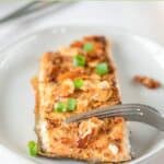 Air fryer salmon almondine and a fork on a plate.