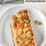 A piece of air fryer salmon almondine on a plate.