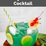 Homemade Bennigan's paddy o' punch cocktail in a small fishbowl on a wood board.